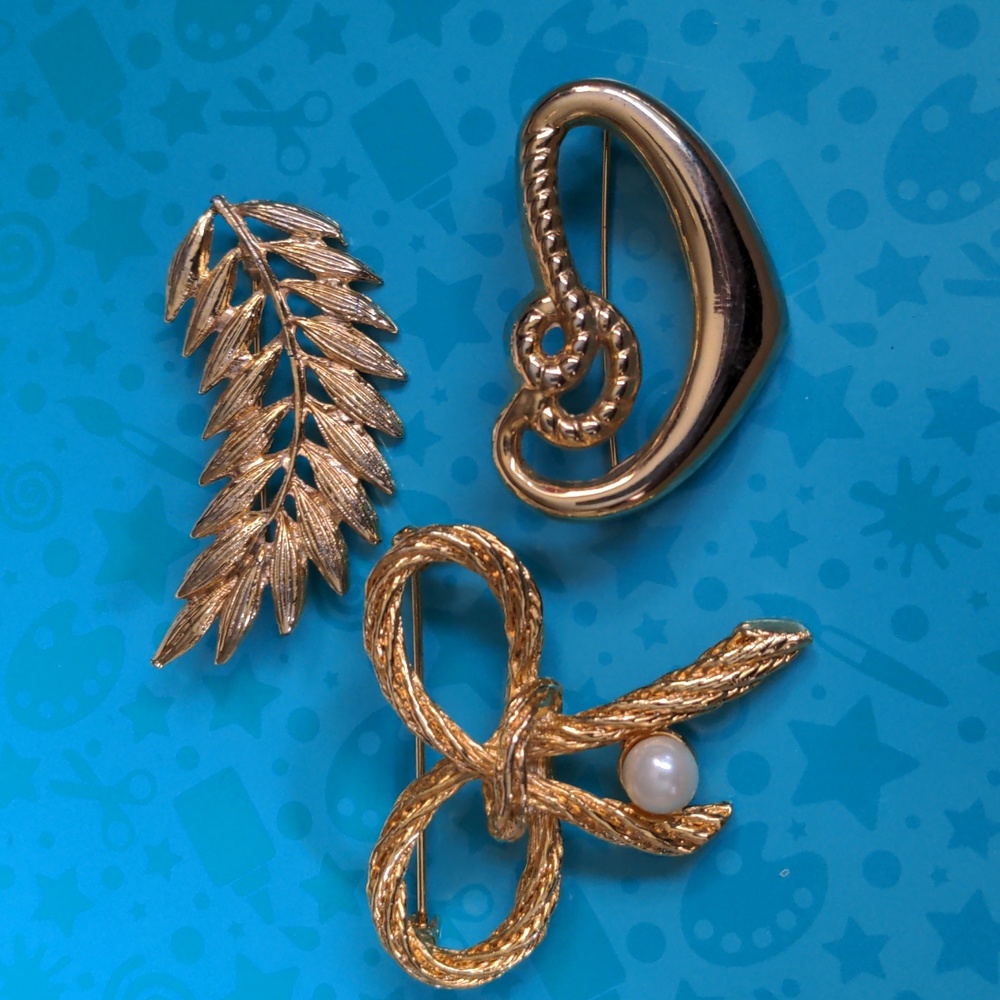 Three AAi Gold Tone Brooches A177